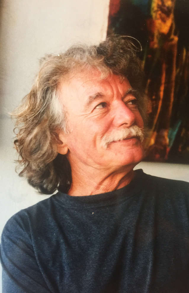 a person with long hair and mustache looking up