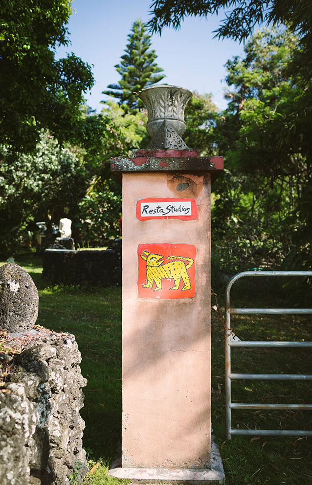 a stone pillar with a metal gate and a statue