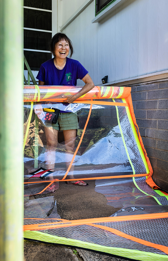 Woman holding a large roll of material used to create watercrafts.