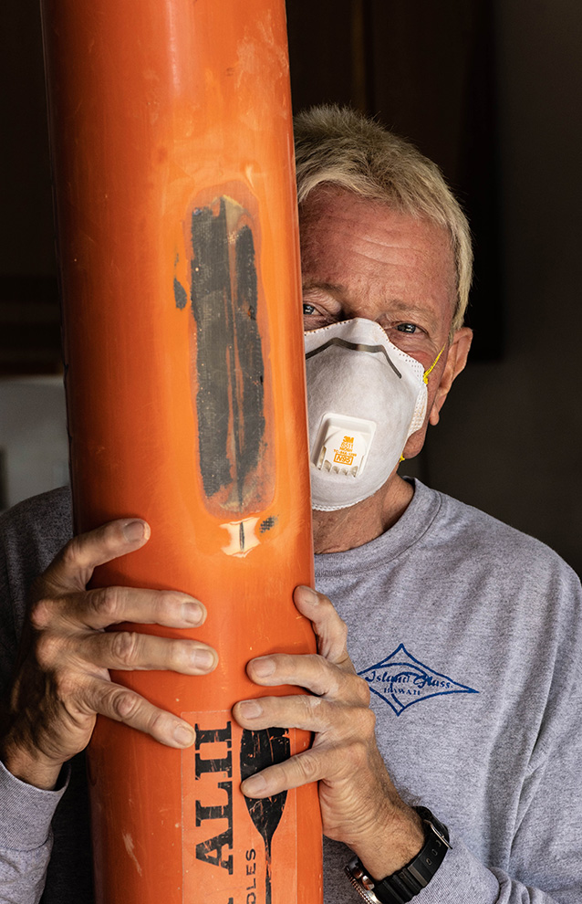 Man holds a piece for a watercraft
