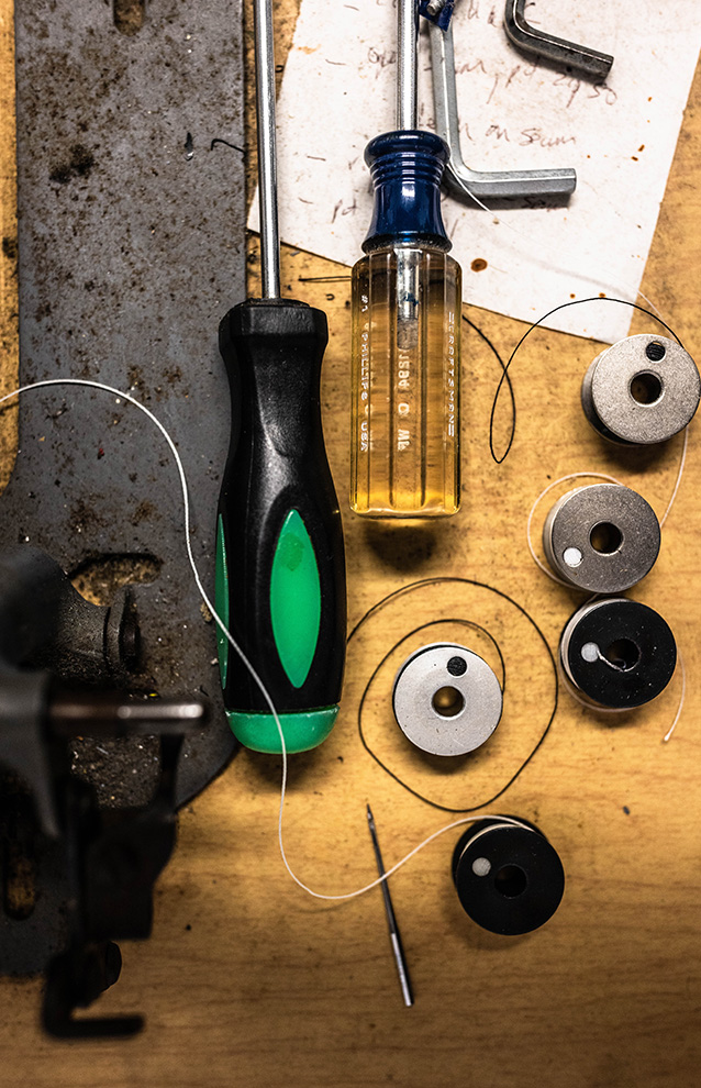 An overhead shot (flat lay) of tools such a bolts, washers, and screwdrivers.
