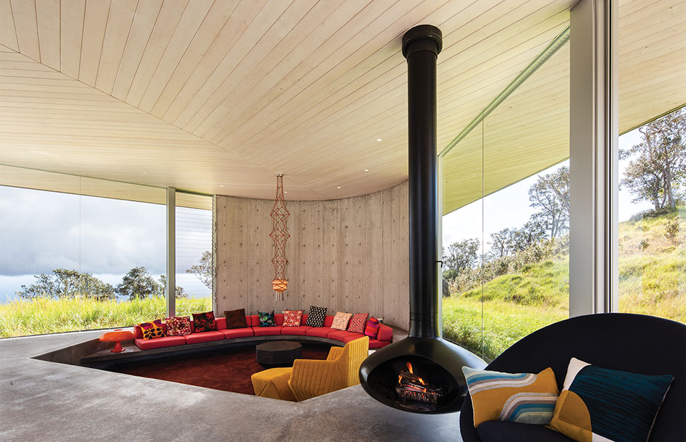 a room with a round fireplace and a couch