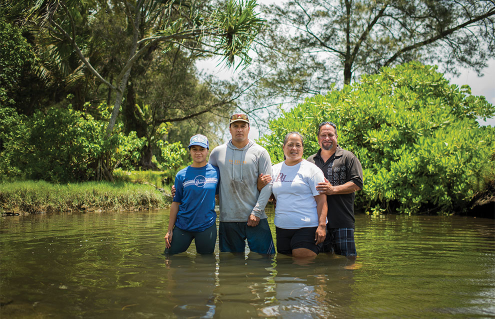 a group of people standing in water