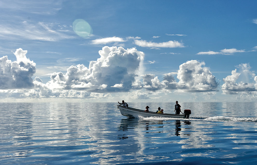 a group of people in a boat on the water