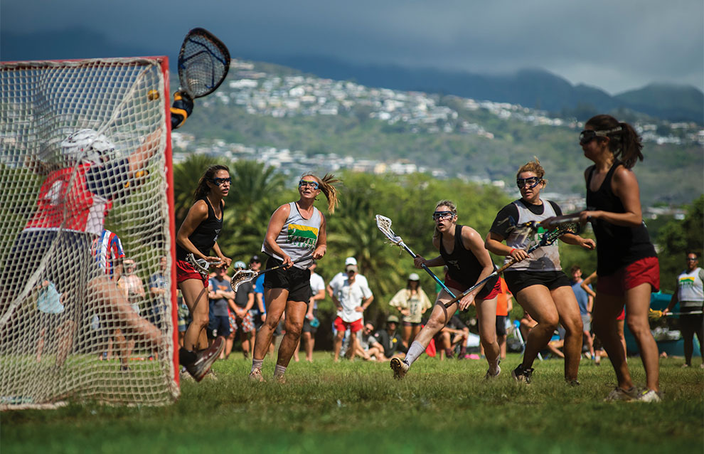 women lacrosse players in action on the field.