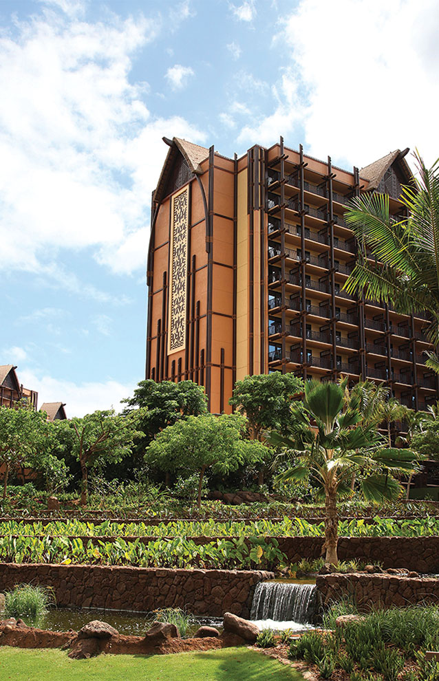 tall brown building surrounded by trees.