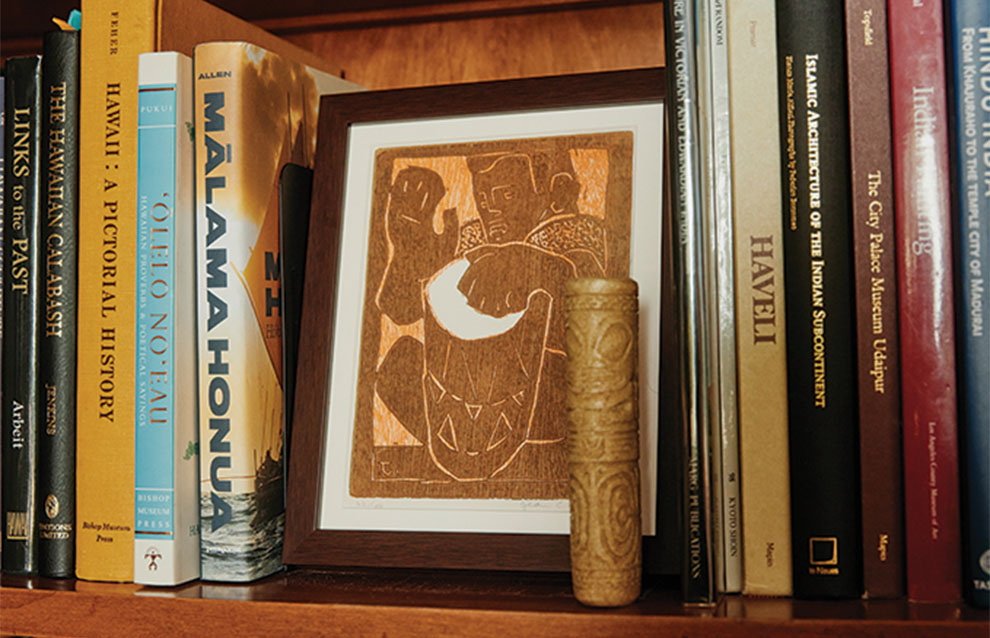 small framed artwork on bookshelf.