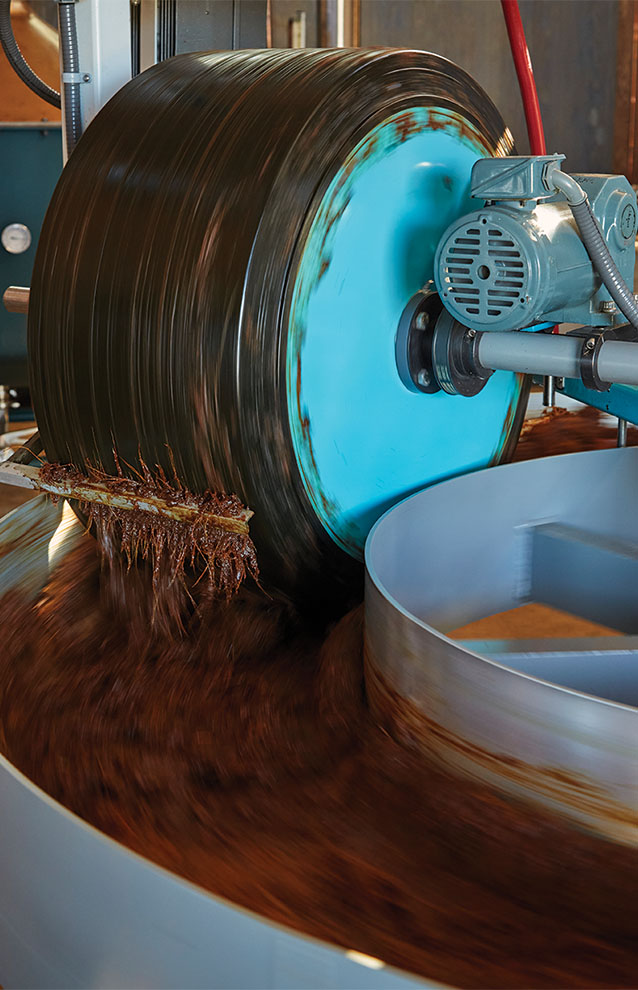 inside the distillery, a large round machine with a blue cover