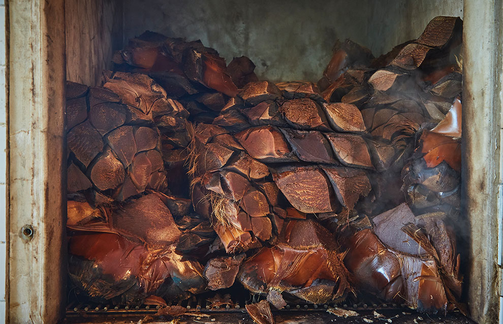 stacks of wood smoking in the distillery