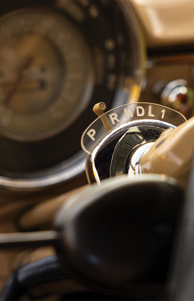 close-up of gear shift inside vintage car.