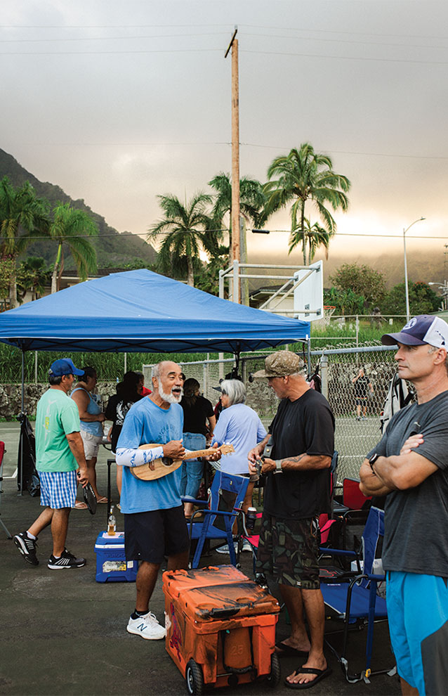 group of friends gathering around tents to watch pickleball games