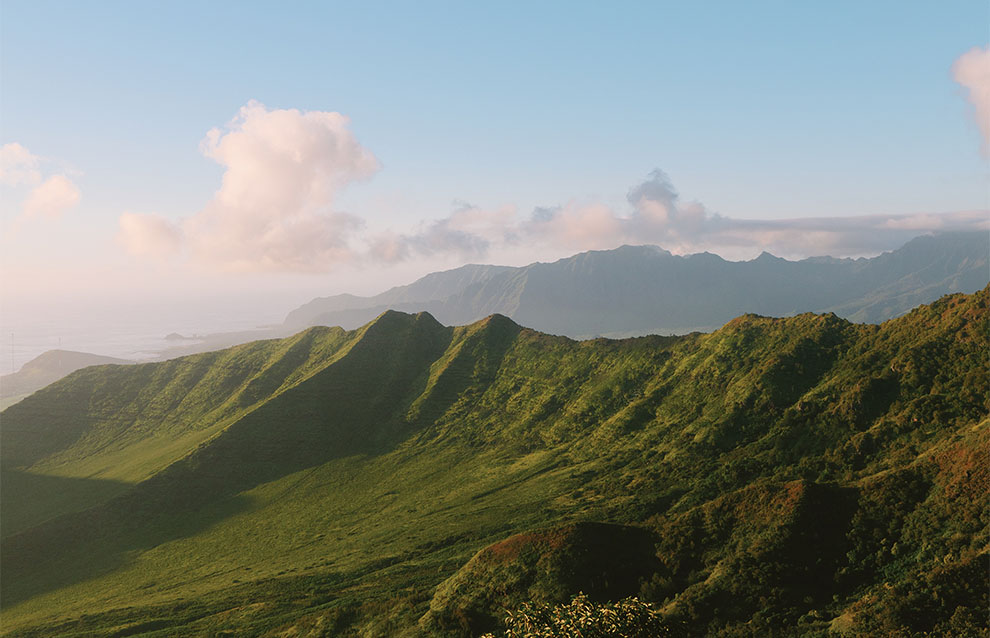 mountains in the distance with blue skies and a few wispy clouds.