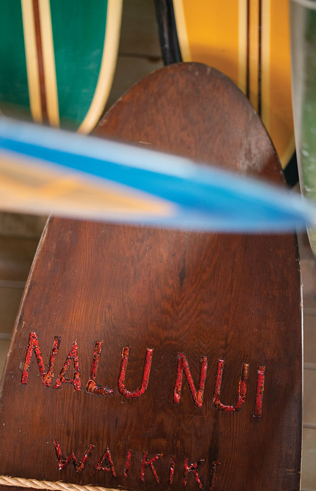 a wood board with a name carved on it.