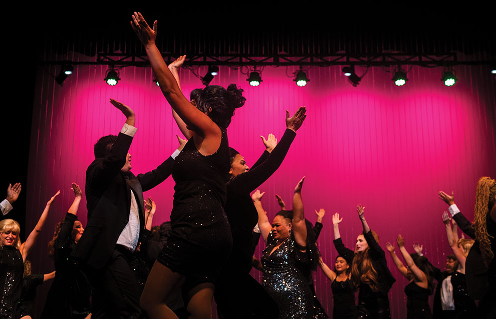 a group of people dancing on a stage