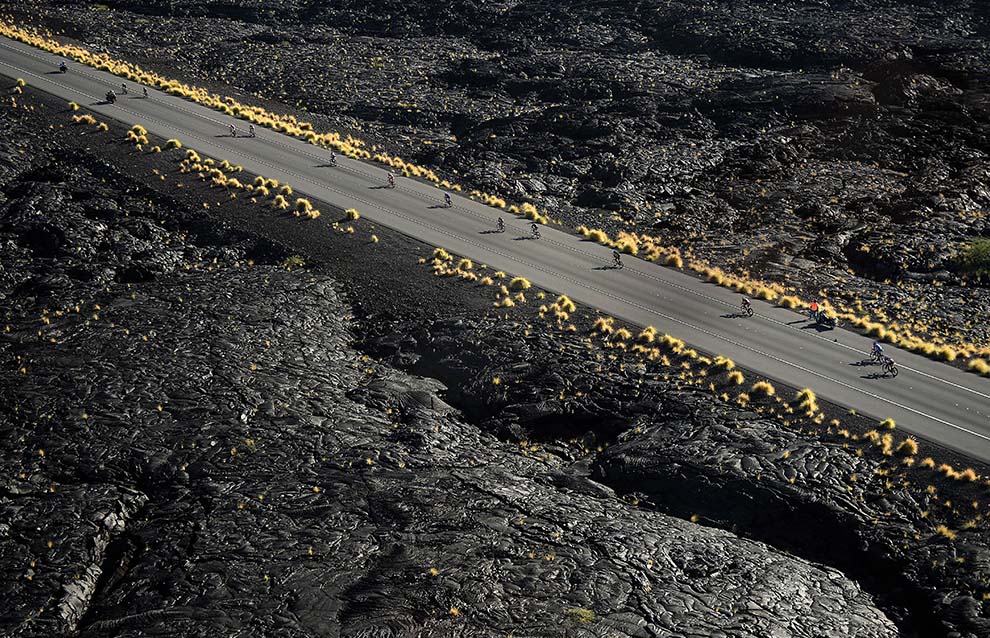 a group of people riding bikes on a road