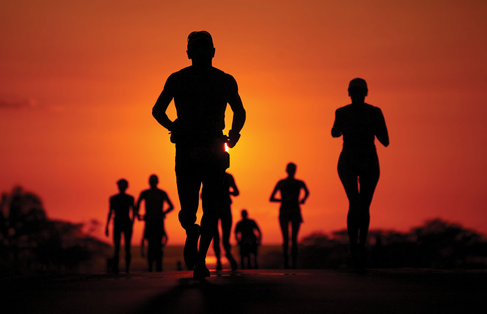 a group of people running in the sun