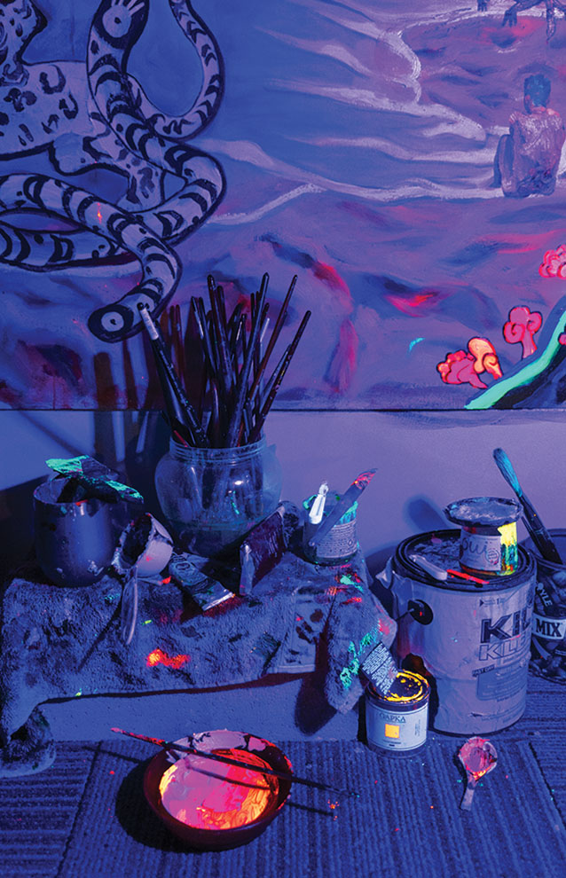 a paint brushes and paint cans in a room