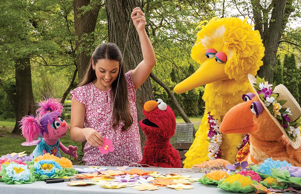 a person holding a piece of paper with other puppets