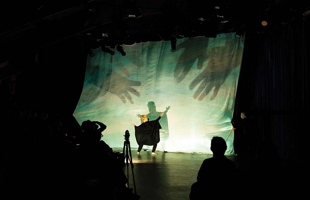 a group of people watching a perforpersonce