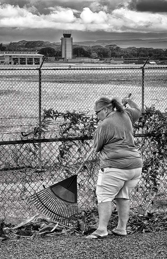 a person raking leaves in a field