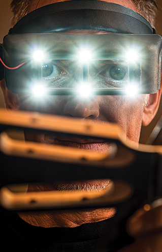 a person with a device with lights on his eyes