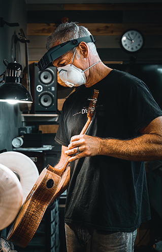 a person wearing a mask and holding a guitar