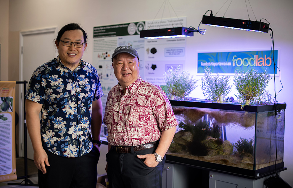 two people standing in front of an indoor aquarium